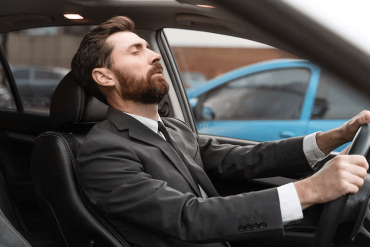 Driver looking tired on a long highway drive
