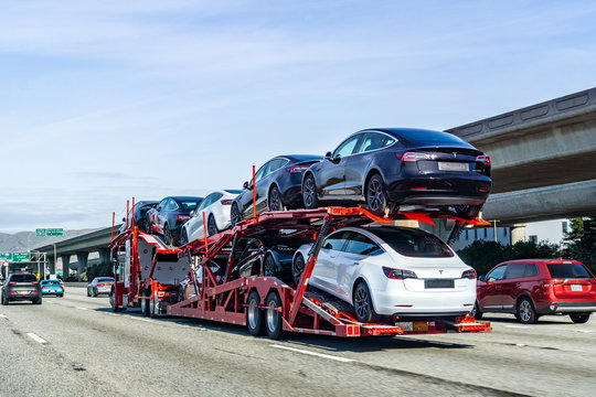Open car carrier transporting vehicles